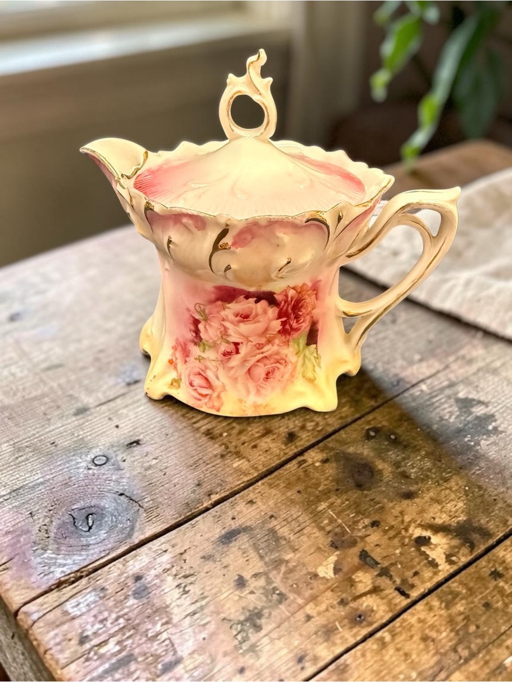 A vintage R. S. Prussia Russian porcelain creamer with pink roses and gold trim.